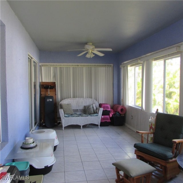 interior space with ceiling fan