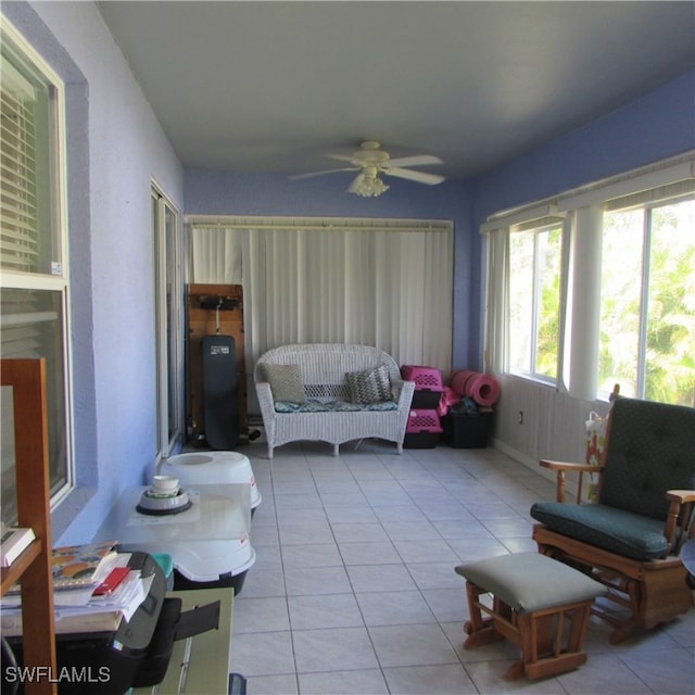 sunroom featuring ceiling fan