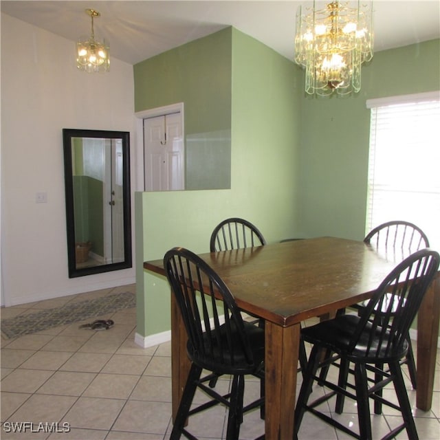 dining area featuring a chandelier and light tile patterned flooring