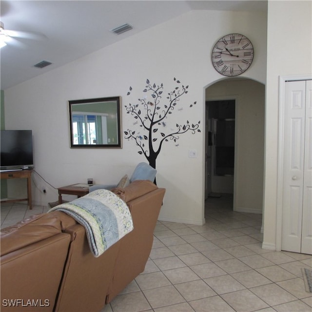 tiled living room featuring vaulted ceiling and ceiling fan