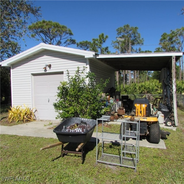 garage with a carport and a yard