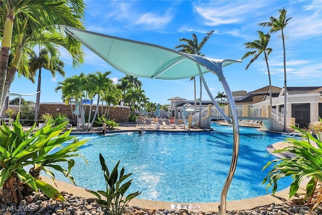 pool featuring fence and a patio area