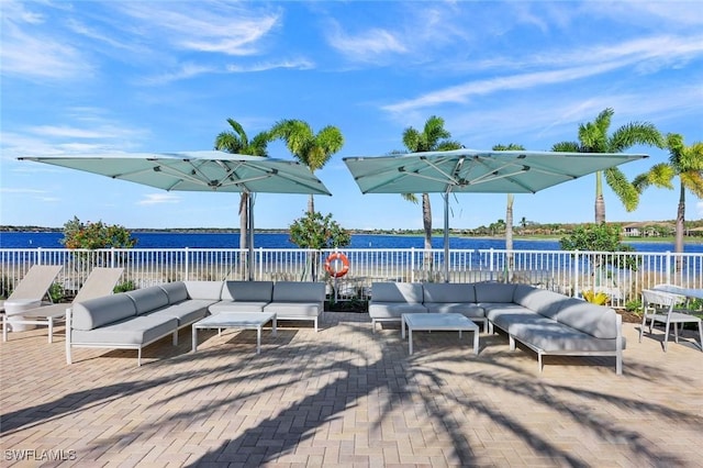 view of patio / terrace with a fenced backyard, a water view, and outdoor lounge area
