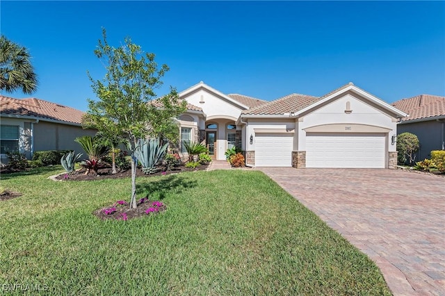 view of front of property with a front yard, decorative driveway, an attached garage, stone siding, and stucco siding