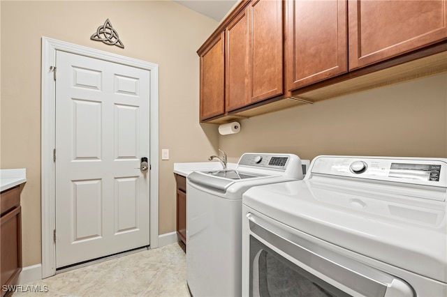 washroom featuring washer and clothes dryer, cabinets, light tile patterned floors, and sink