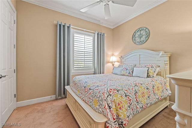 carpeted bedroom featuring crown molding, a ceiling fan, and baseboards