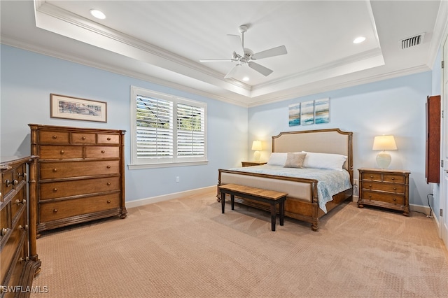 bedroom featuring light colored carpet, ceiling fan, a raised ceiling, and ornamental molding