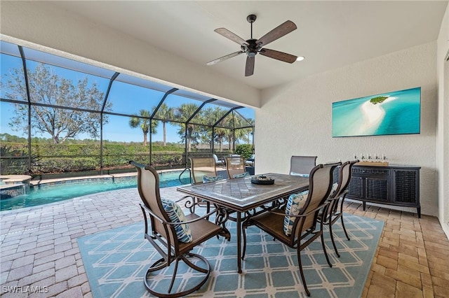 view of patio with an outdoor pool, a ceiling fan, glass enclosure, a hot tub, and outdoor dining space