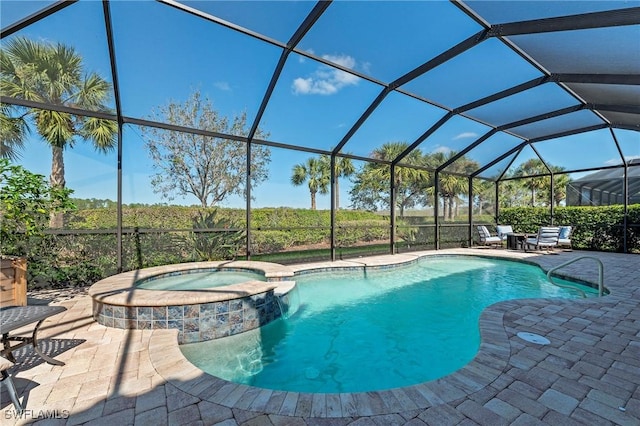 view of swimming pool featuring glass enclosure, a pool with connected hot tub, and a patio area
