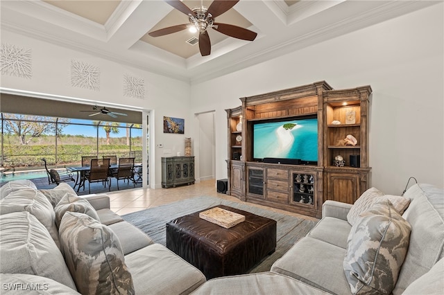 tiled living room featuring beam ceiling, ceiling fan, coffered ceiling, a towering ceiling, and ornamental molding