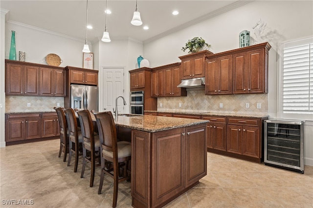 kitchen featuring pendant lighting, crown molding, wine cooler, an island with sink, and appliances with stainless steel finishes