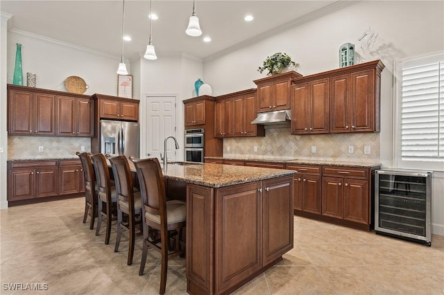 kitchen with ornamental molding, decorative backsplash, beverage cooler, a breakfast bar area, and appliances with stainless steel finishes
