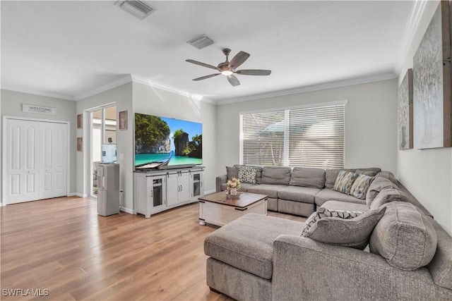 living room featuring light hardwood / wood-style flooring, ceiling fan, and ornamental molding