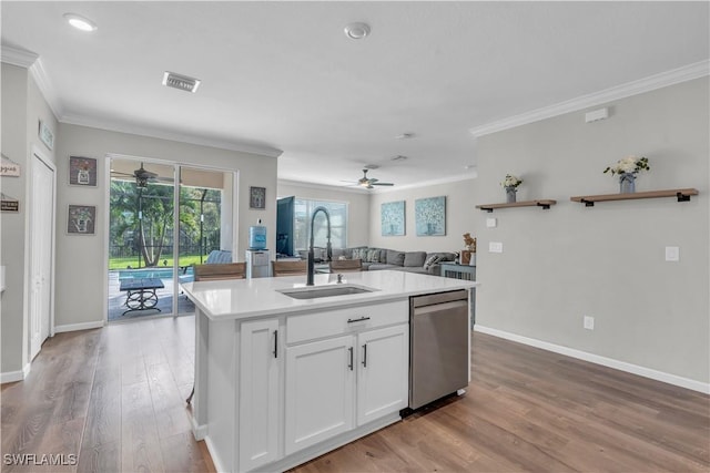 kitchen featuring stainless steel dishwasher, sink, light hardwood / wood-style floors, white cabinetry, and an island with sink