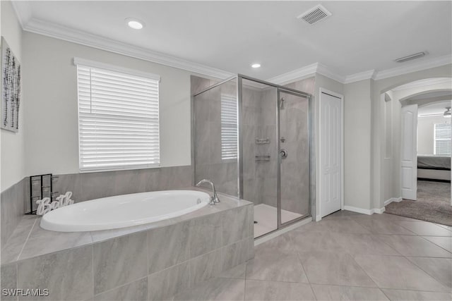 bathroom with tile patterned flooring, plenty of natural light, and crown molding