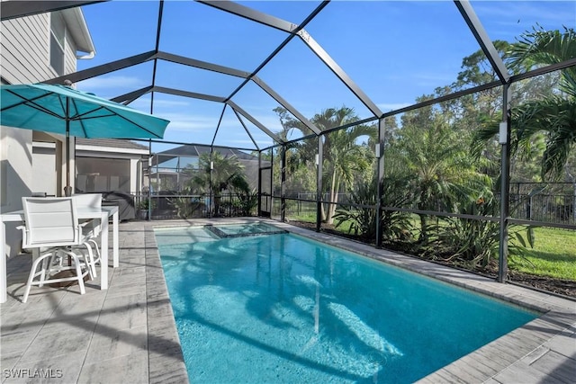 view of swimming pool with glass enclosure and a patio