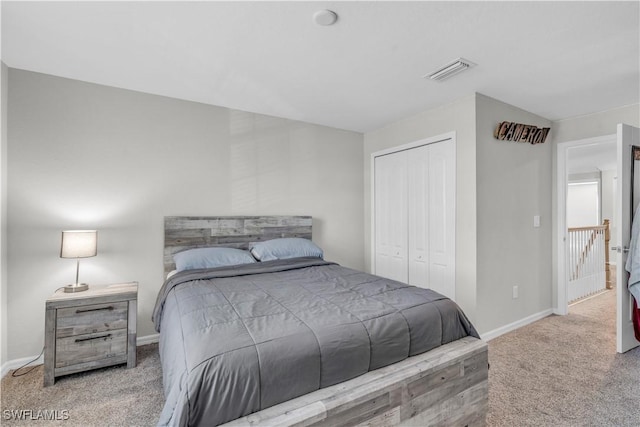 bedroom with a closet and light colored carpet