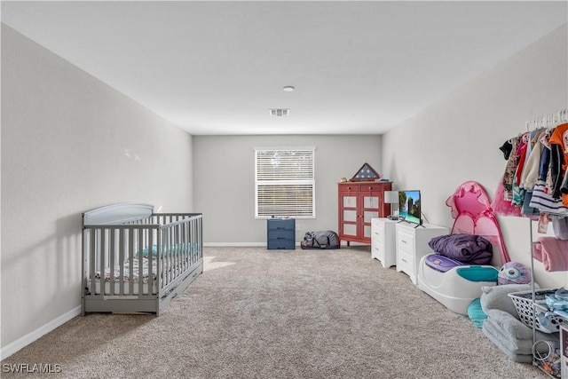 bedroom with carpet and a nursery area