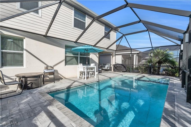 view of swimming pool with a lanai and a patio