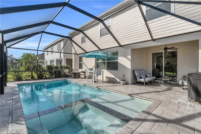 view of pool featuring a lanai, ceiling fan, and a patio area