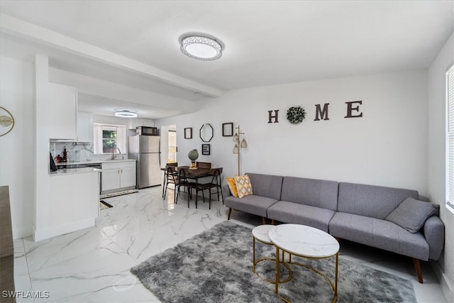 living room with beamed ceiling and sink