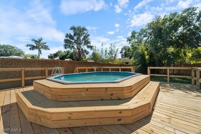 view of swimming pool with a deck