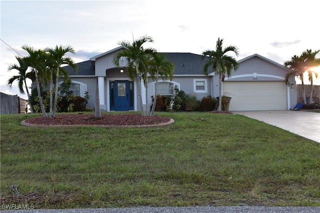 ranch-style home featuring a garage and a front lawn