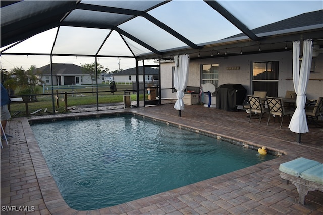 view of pool with a patio, a lanai, and a grill