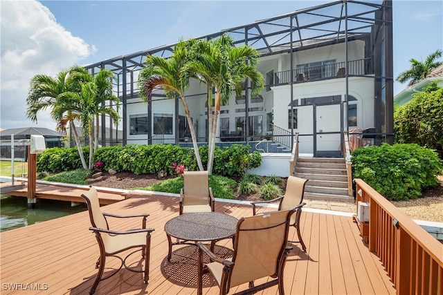 exterior space with a lanai and a water view