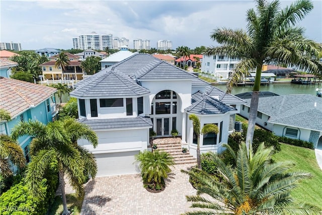 view of front facade with a garage and a water view