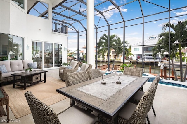 sunroom / solarium featuring a water view