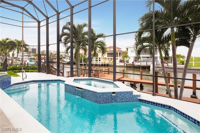 view of pool featuring an in ground hot tub, a water view, and glass enclosure