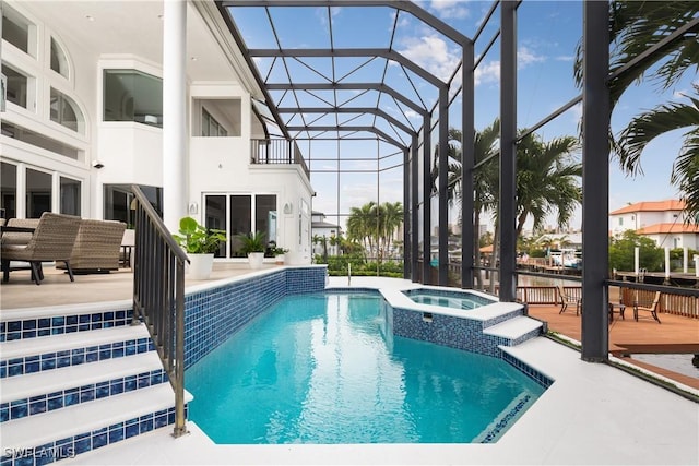 view of swimming pool featuring a lanai, an in ground hot tub, and a patio