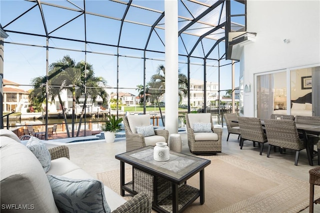 view of patio / terrace with an outdoor living space, a lanai, a water view, and a swimming pool