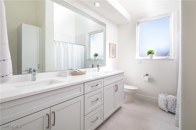 bathroom featuring vanity and toilet