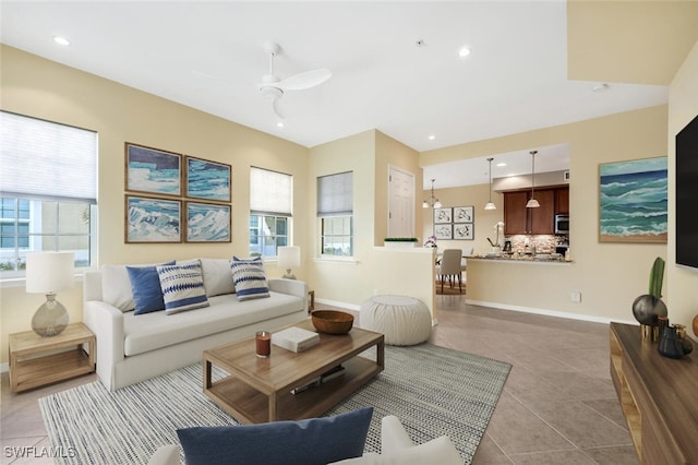 living room with ceiling fan and light tile patterned floors