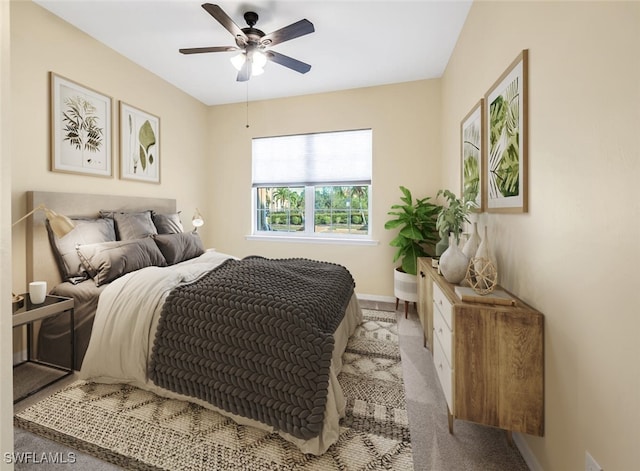 bedroom featuring ceiling fan and light carpet