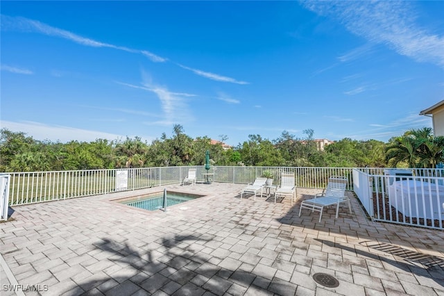 view of pool with a community hot tub and a patio