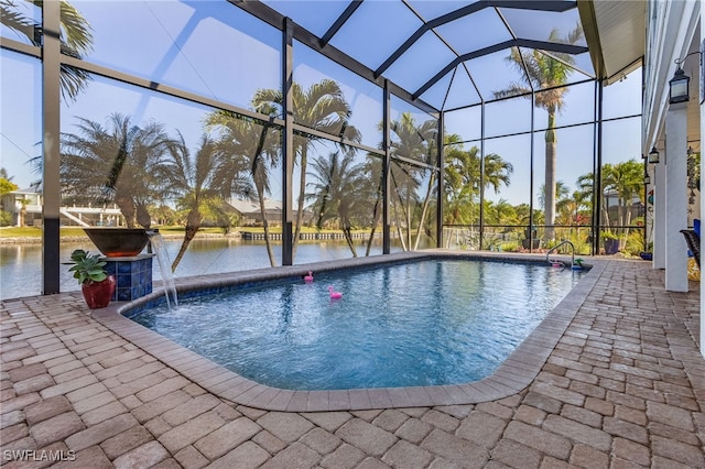 view of pool featuring a lanai, a patio area, pool water feature, and a water view