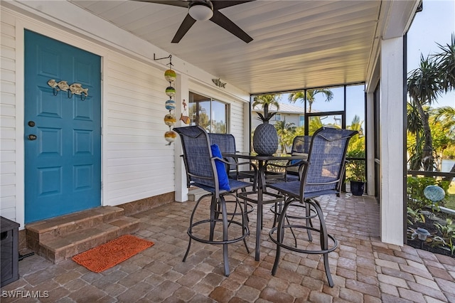 sunroom / solarium featuring ceiling fan