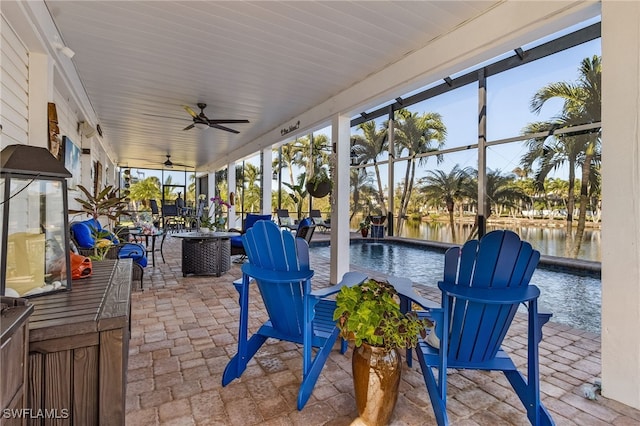 view of patio featuring ceiling fan and a water view