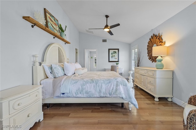 bedroom with ceiling fan, vaulted ceiling, and light hardwood / wood-style flooring