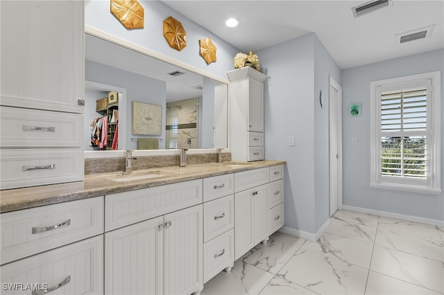 bathroom with vanity and a shower