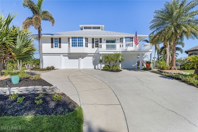 coastal inspired home featuring a porch and a garage