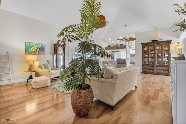 living room with lofted ceiling and light wood-type flooring