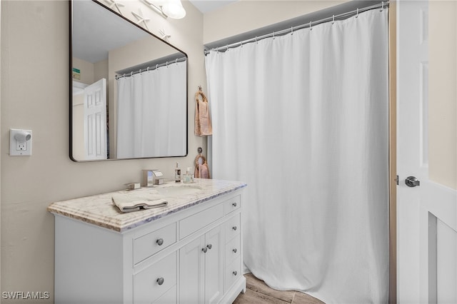 bathroom with hardwood / wood-style floors and vanity