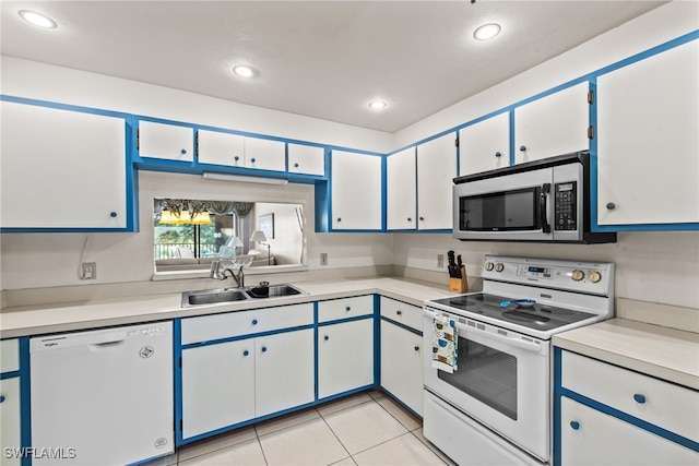 kitchen featuring sink, white cabinets, white appliances, and light tile patterned floors