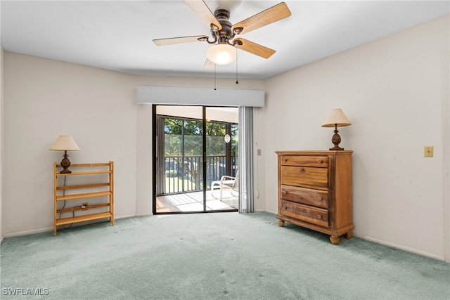 interior space with carpet flooring and ceiling fan