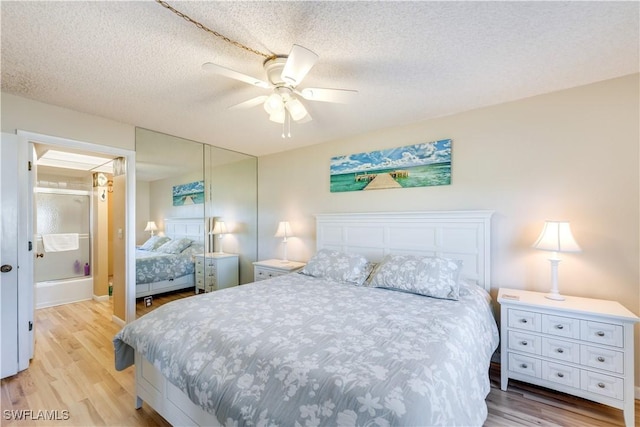 bedroom with ceiling fan, light hardwood / wood-style flooring, and a textured ceiling