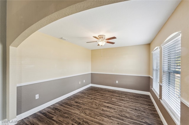 spare room with ceiling fan and dark hardwood / wood-style flooring